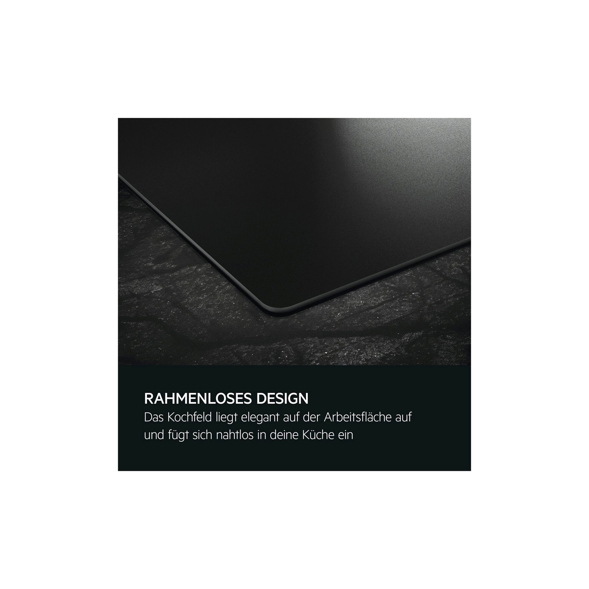 Die Ecke eines rahmenlosen schwarzen Kochfelds liegt flach und bündig auf einer dunklen Arbeitsplatte.