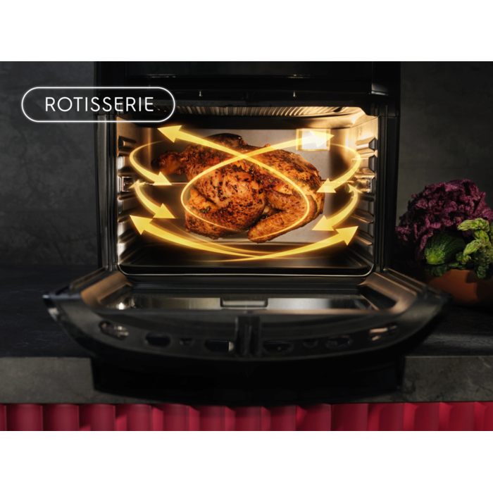 Airfryer mit offenem Garraum; ein gegrilltes Hähnchen wird mit gelben Pfeilen für Rotisserie‑Luftströmung dargestellt