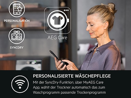 Frau bedient Smartphone, im Hintergrund moderne Waschmaschine.